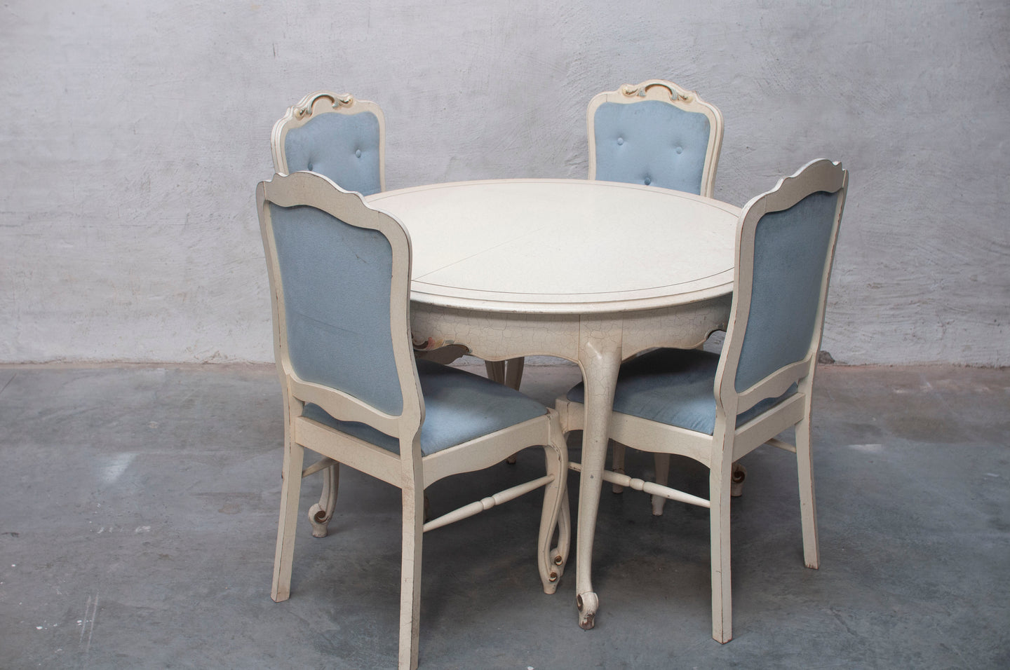 Louis XV dining room table with four chairs.